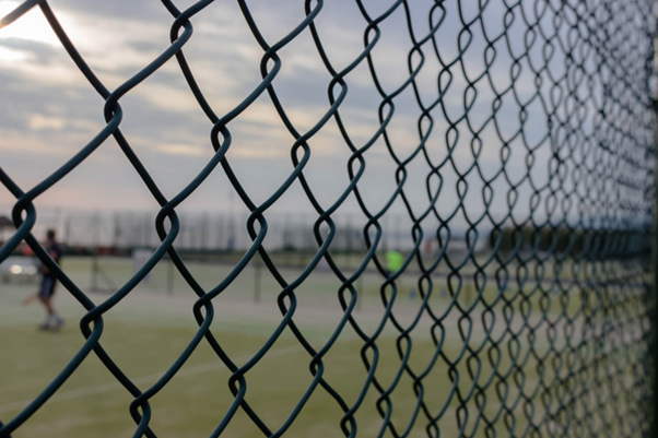 Close-up view of black PVC-coated chain wire mesh fencing with diamond pattern